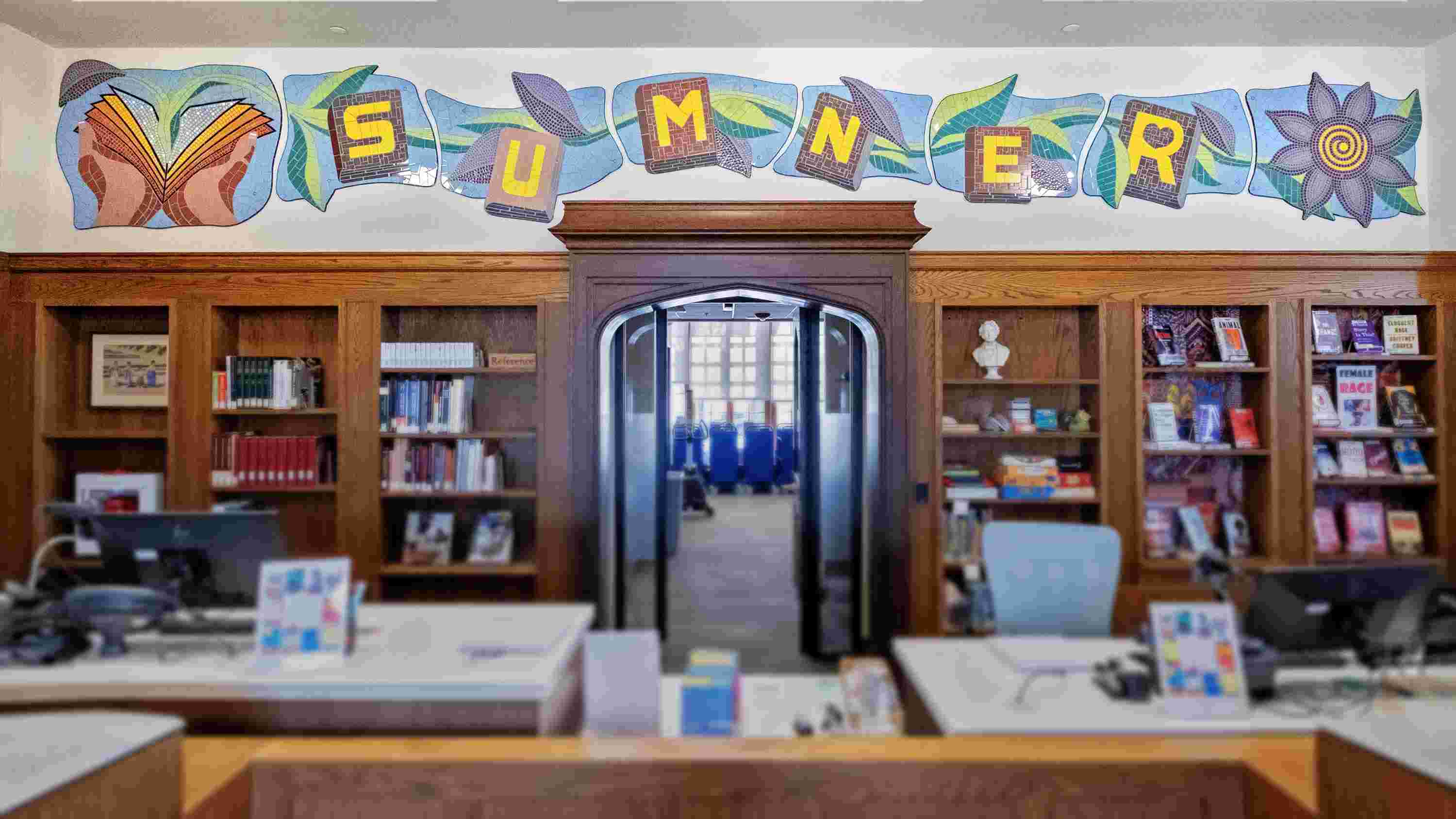 a photo of the interior of the Sumner Library that highlights tile art that spells out "Sumner"