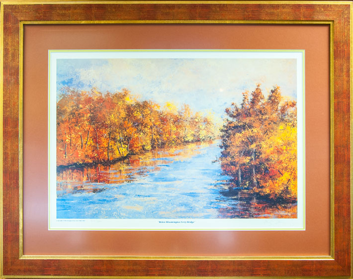 Framed print of a river with trees on both banks in the fall