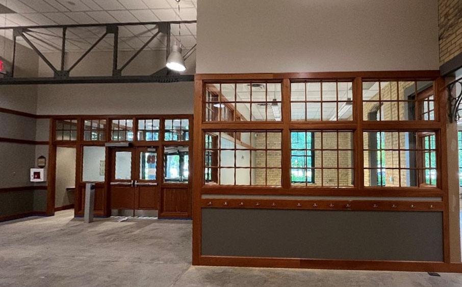 empty interior of pierre bottineau library facing entrance with walls freshly painted beige and dark green